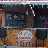 Halftime Restaurant Pizza & Cocktails Logo